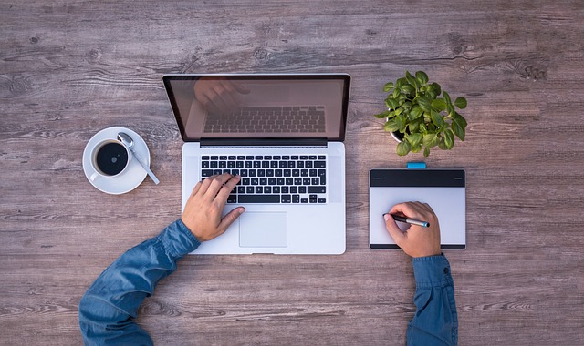 a person using a laptop and a tablet